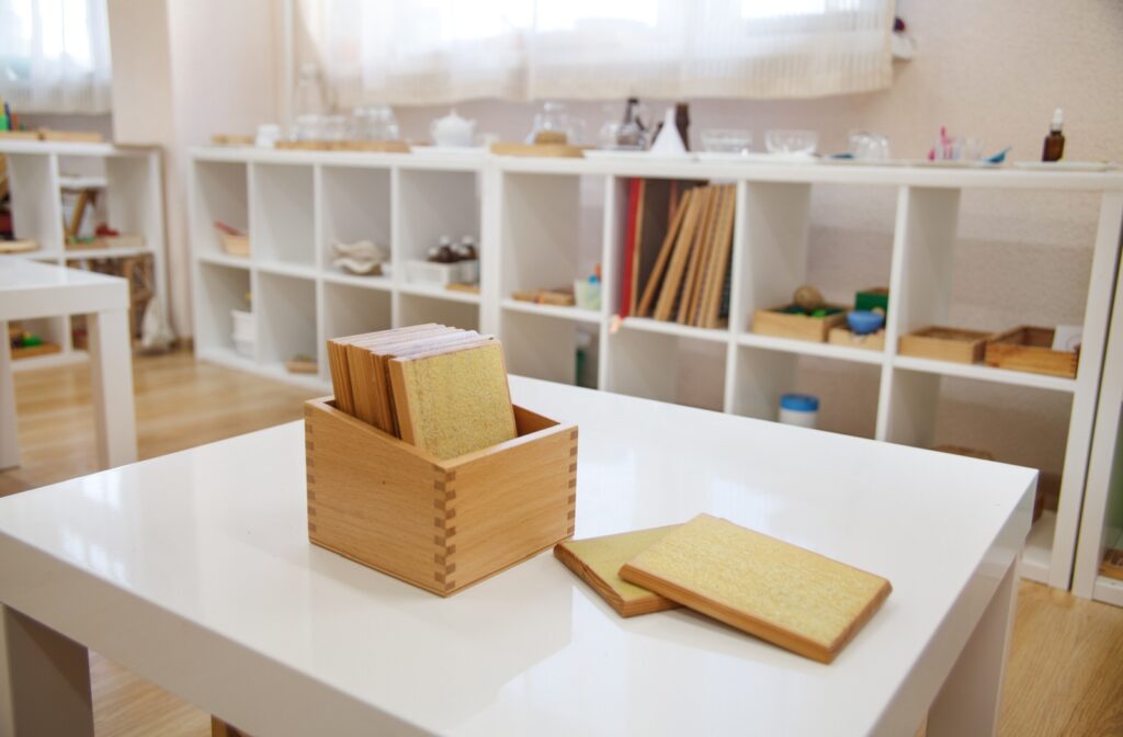 Montessori touch tablets in a box on a white table in the classroom.