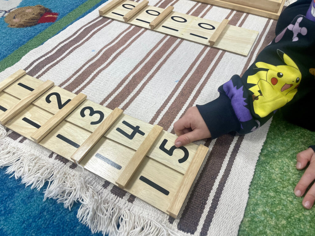 Child using a Montessori counting board.