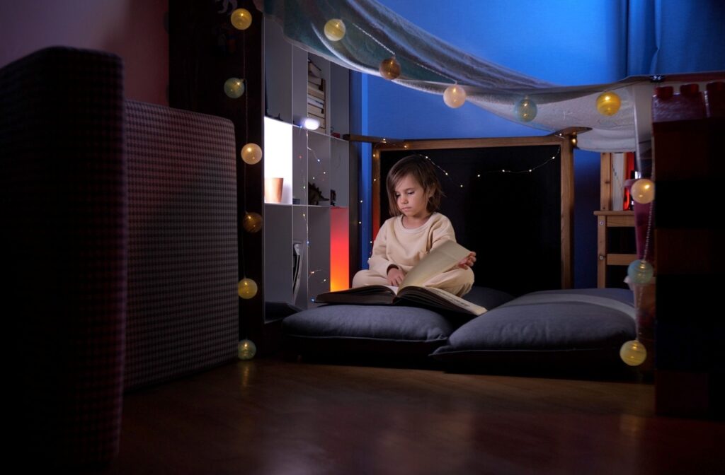 A young child uses a book to help them reflect in their at-home Peace Corner.
